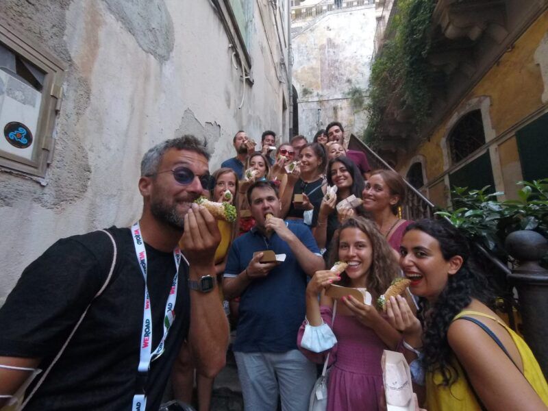 foto de grupo weroad, cada persona está comiendo un cannolo siciliano