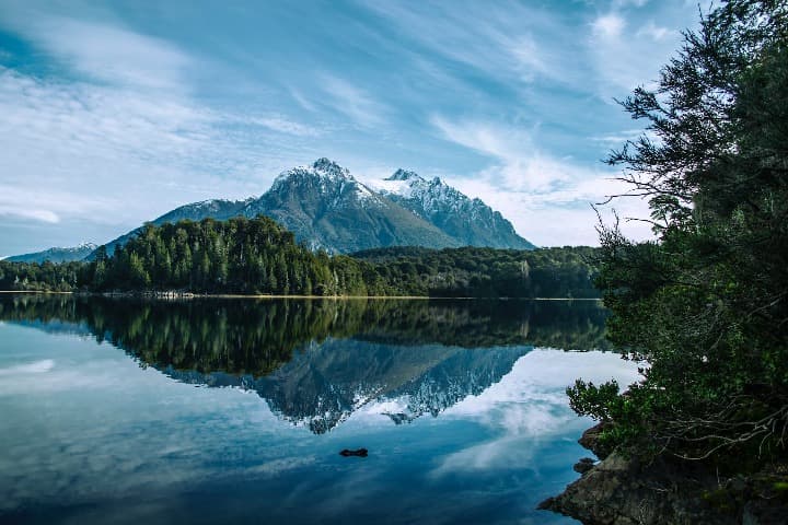 montaña y bosque reflejados en el agua en bariloche - weroad